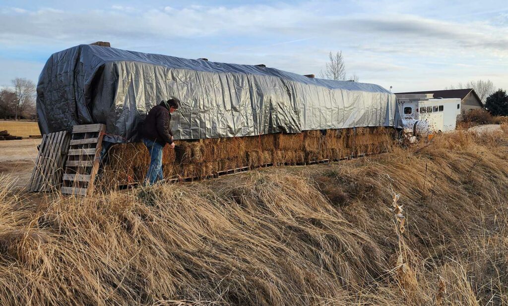 hay covered with tarp for winter storage